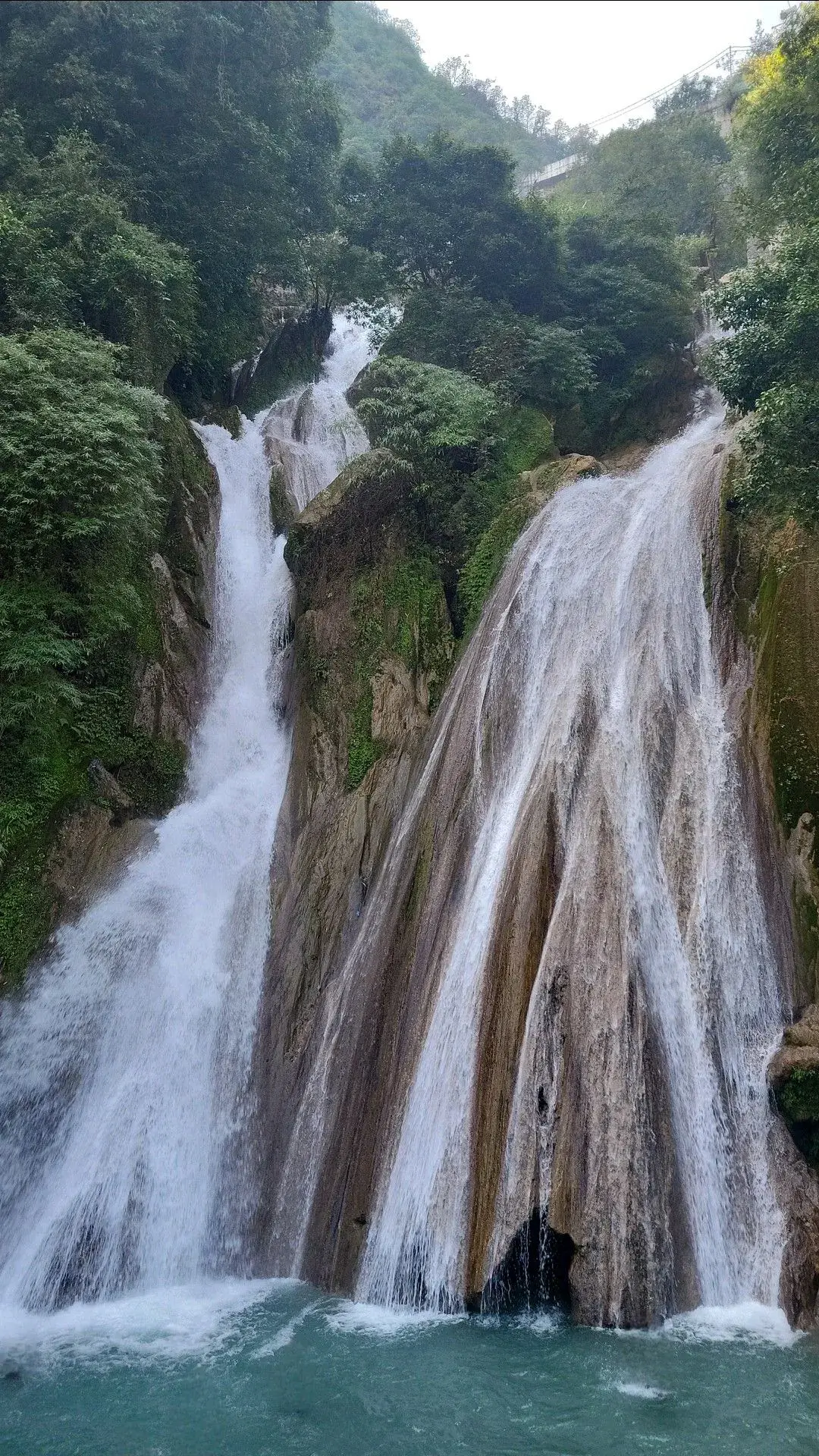 Kempty Falls in Mussoorie surrounded by green hills